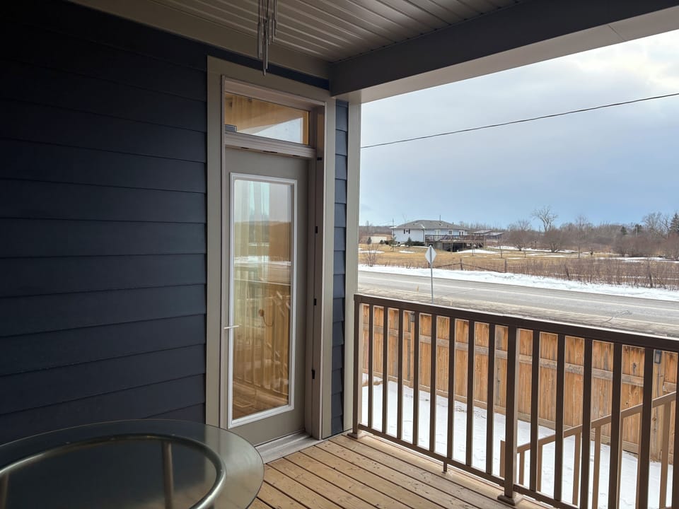 Covered deck with a round table and chairs 