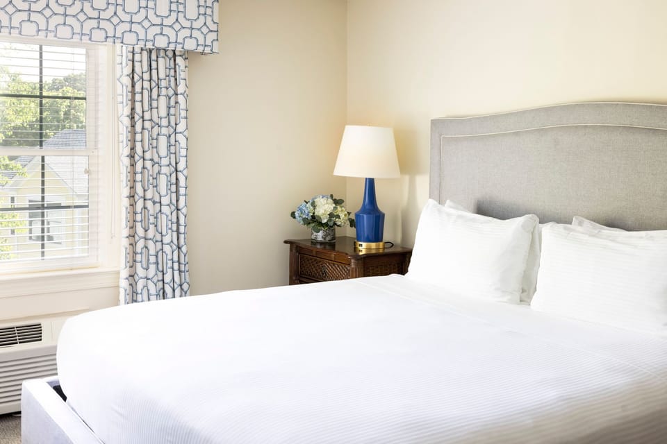 Elegant bedroom with a plush bed, warm lighting, and tasteful decor designed for ultimate comfort.