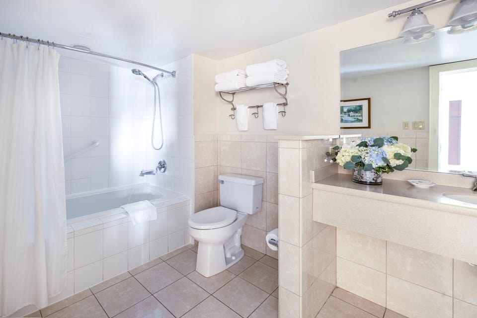 Refreshing bathroom with a spacious vanity, well-lit mirror, and modern fixtures for a spa-like experience.