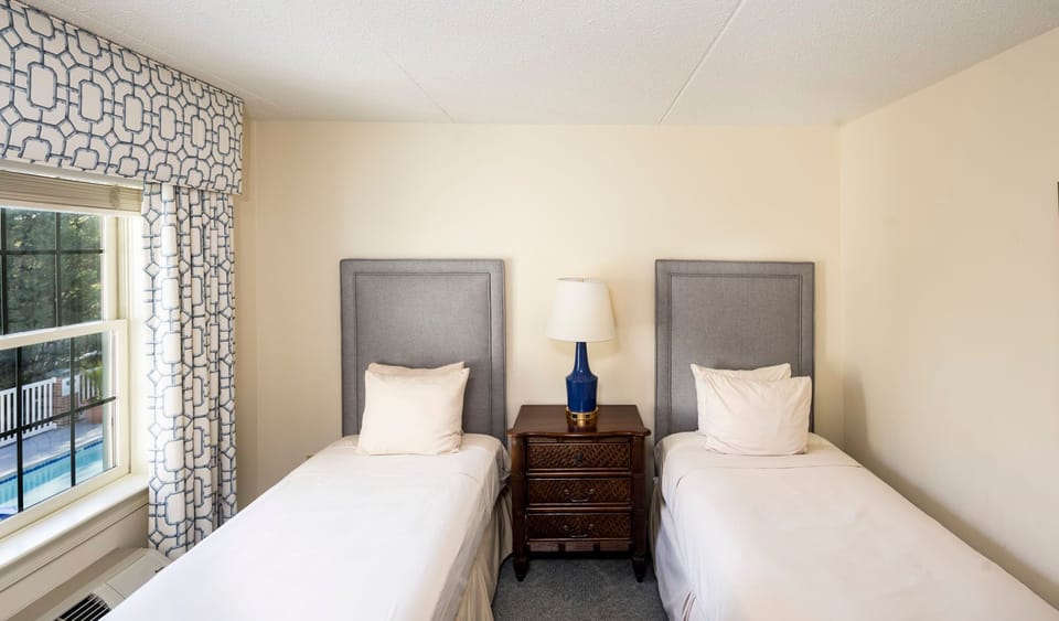 A bright and airy twin room with plush bedding and a peaceful ambiance.