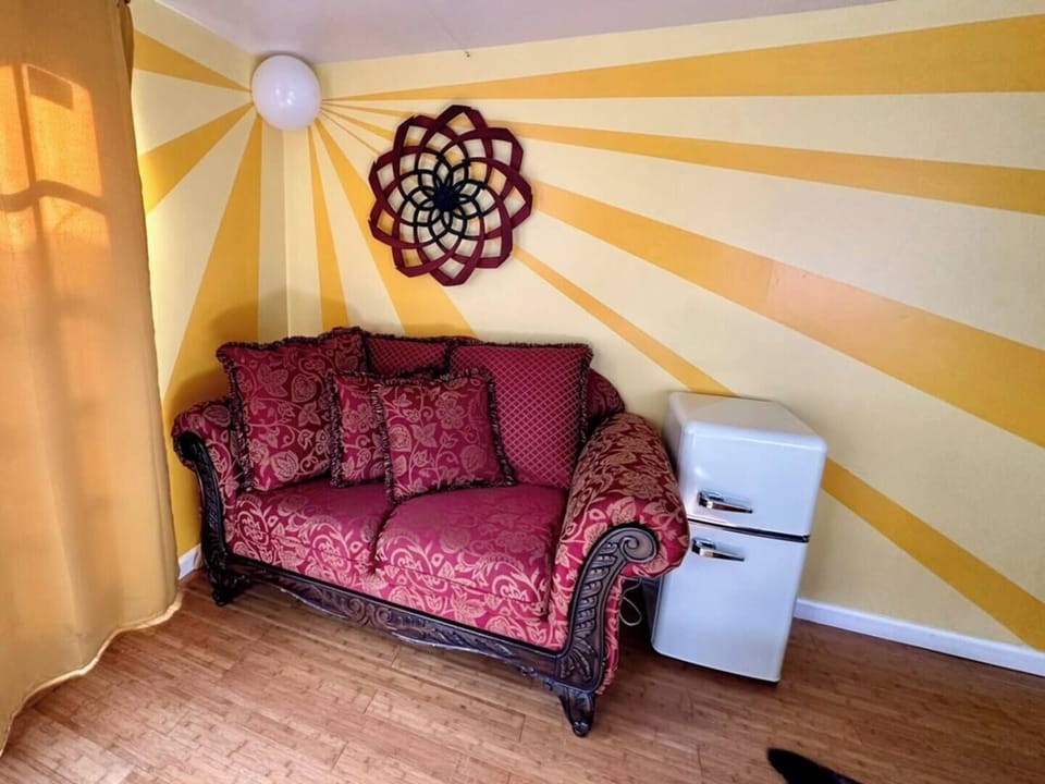 Lounge on the ornate sofa, surrounded by sunburst walls