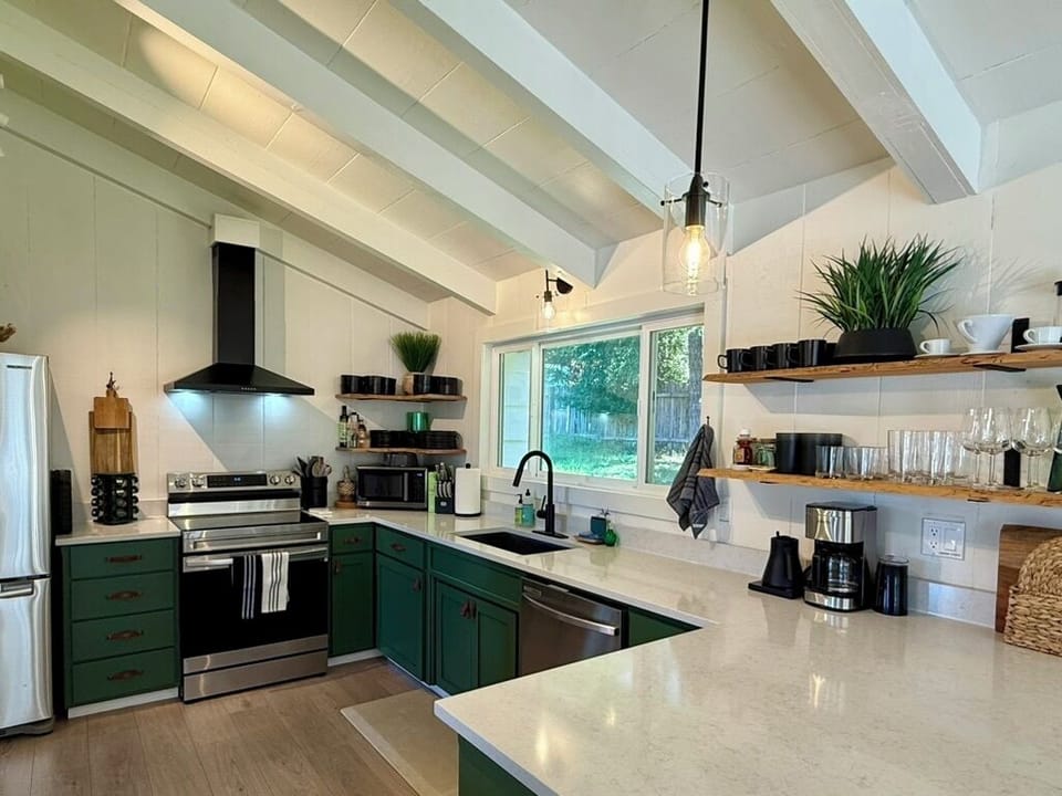 The fully equipped kitchen with a dishwasher is stocked with basic pantry items
