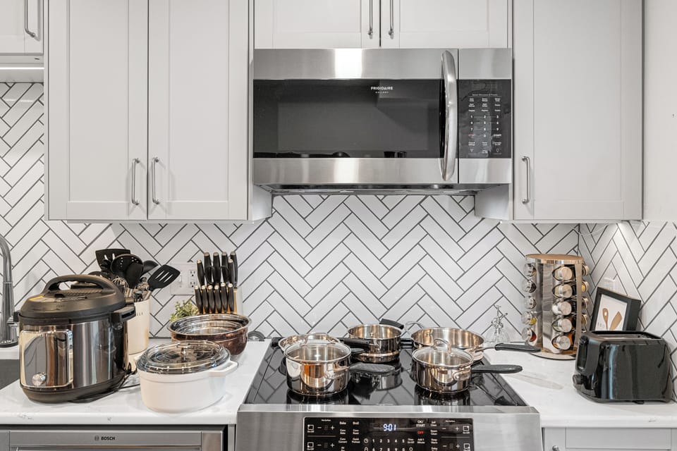 Fully equipped cooking station with a electric cooking top, oven, and air fryer.