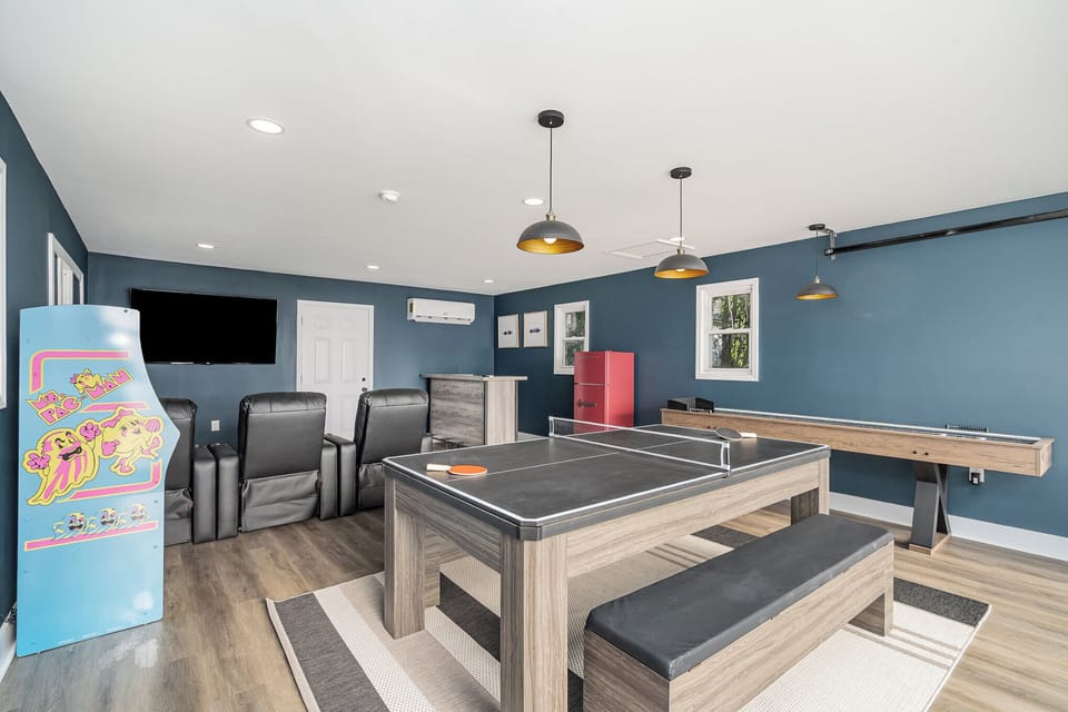 Game on!! Enjoy all of the fun and festivities in the detached garage equipped with a 3 in 1 Ping Pong, Pool Table and Dining Table as well as Shuffleboard, Pac Man, 3 theater seats, 65 inch TV, Bar and fridge to keep your drinks cold.