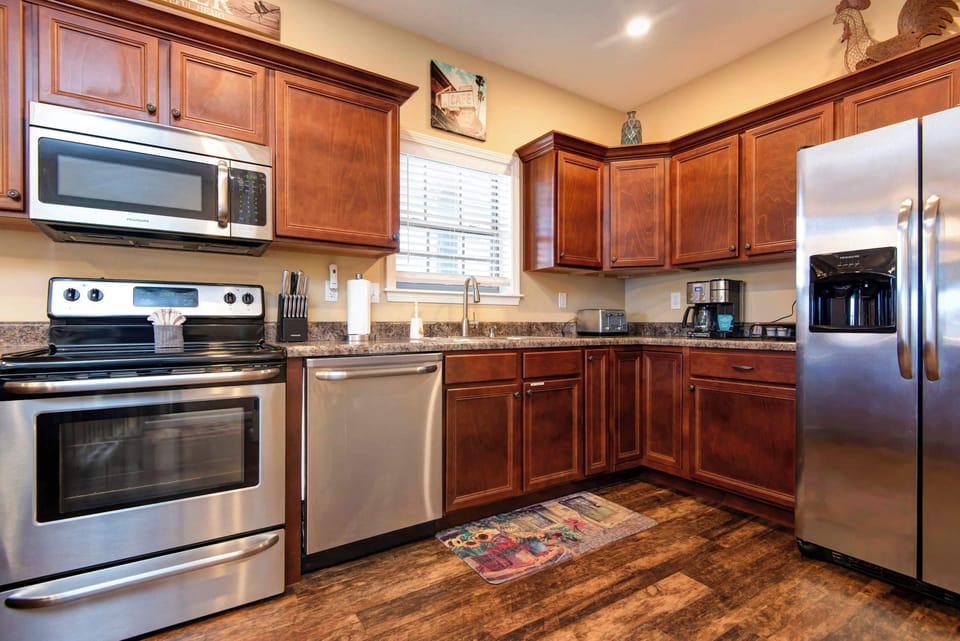 Enjoy a fully equipped kitchen featuring sleek stainless steel appliances, ample counter space, and everything you need for convenient meal preparation.