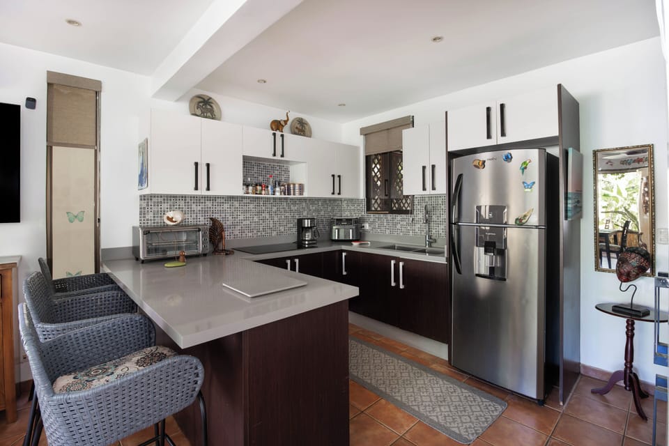The large kitchen has a breakfast bar for dining or working.