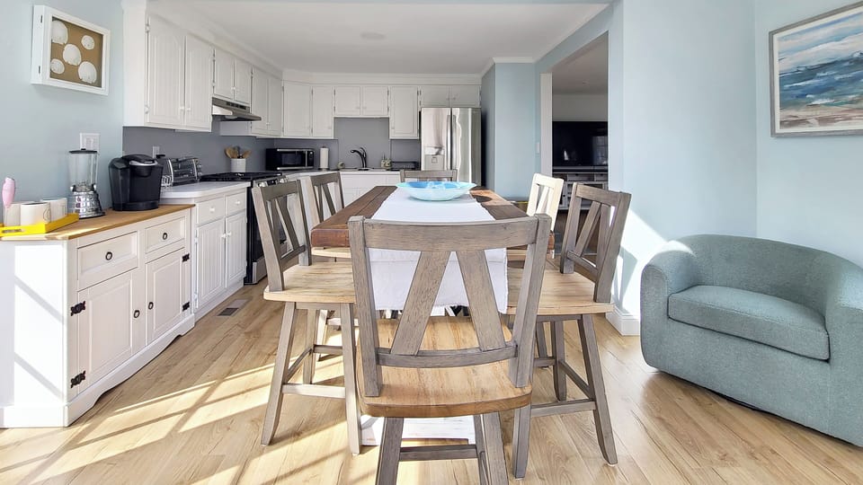 Dining area has a sitting area with two club chairs
