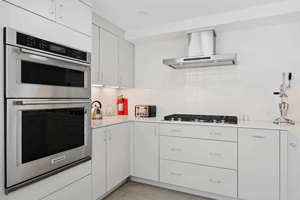The sleek kitchen offers ample space & every home comfort