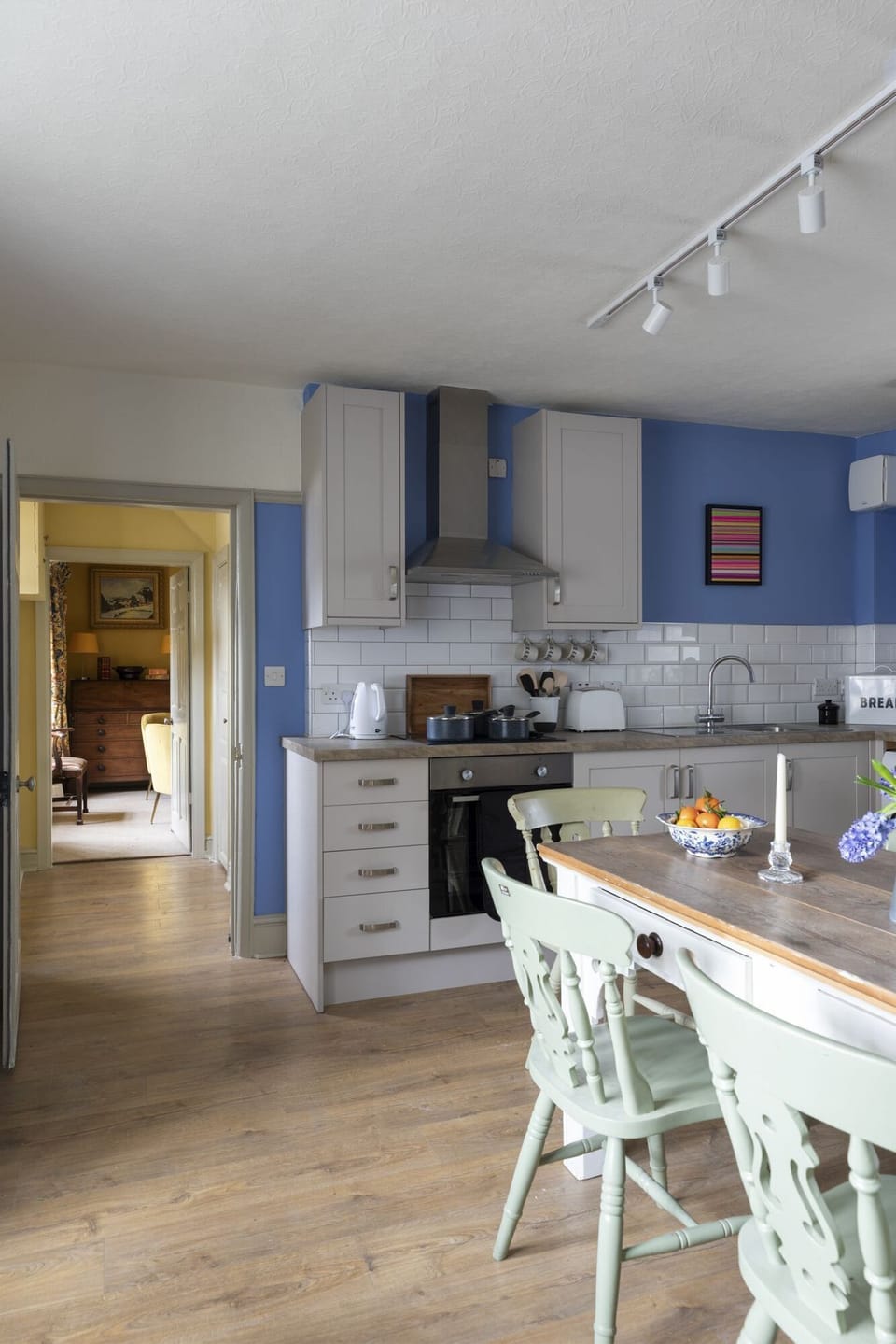 Churchill Cottage - the kitchen and dining area with the living room beyond the hall