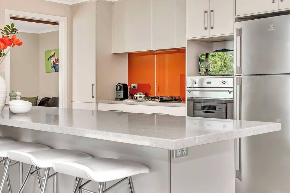 The expansive bench with bar stools invites casual breakfasts and shared culinary adventures.