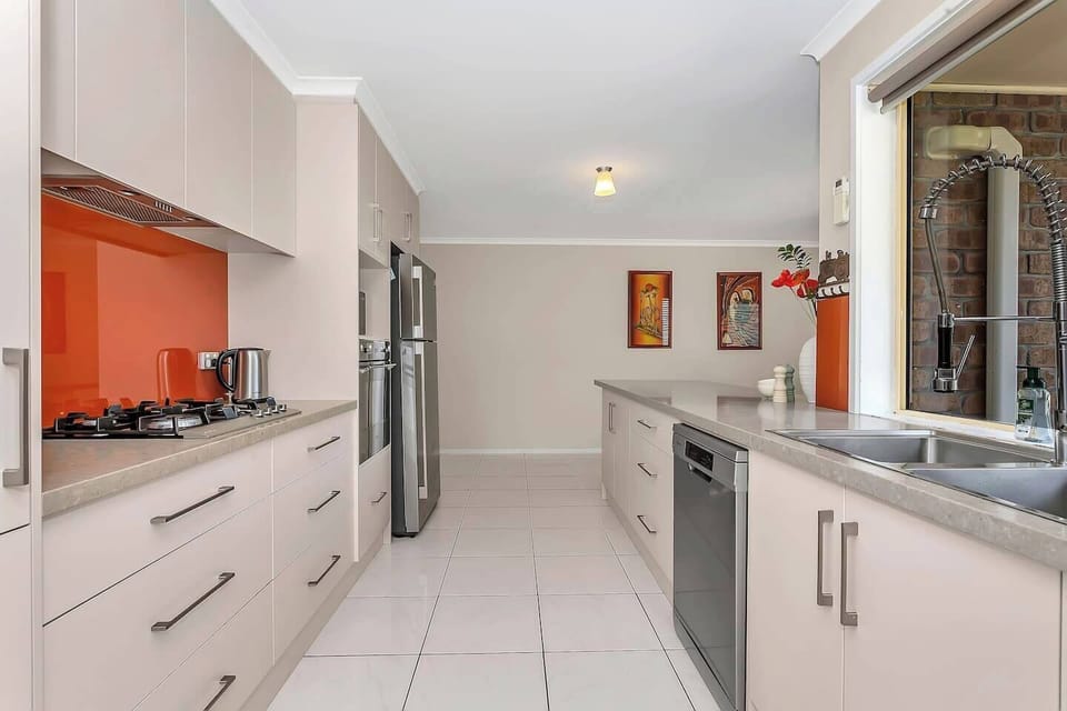 Channel your inner chef in the modern kitchen, equipped with a gas cooktop, oven, espresso machine, and dishwasher.