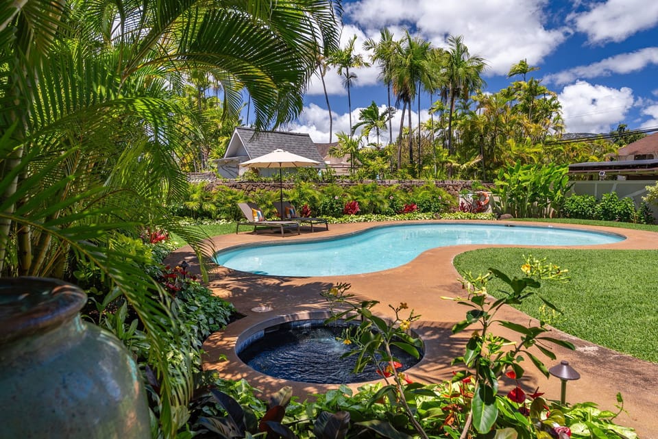 Tropical oasis with a sparkling pool and spa, perfect for rejuvenating after island adventures.