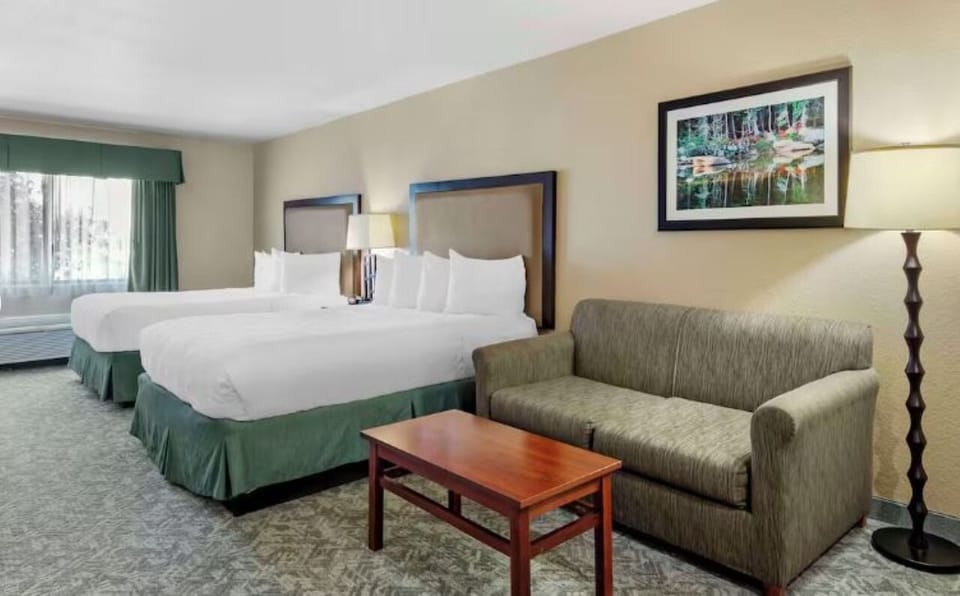 Unwind together in a spacious double-queen room with sofa.