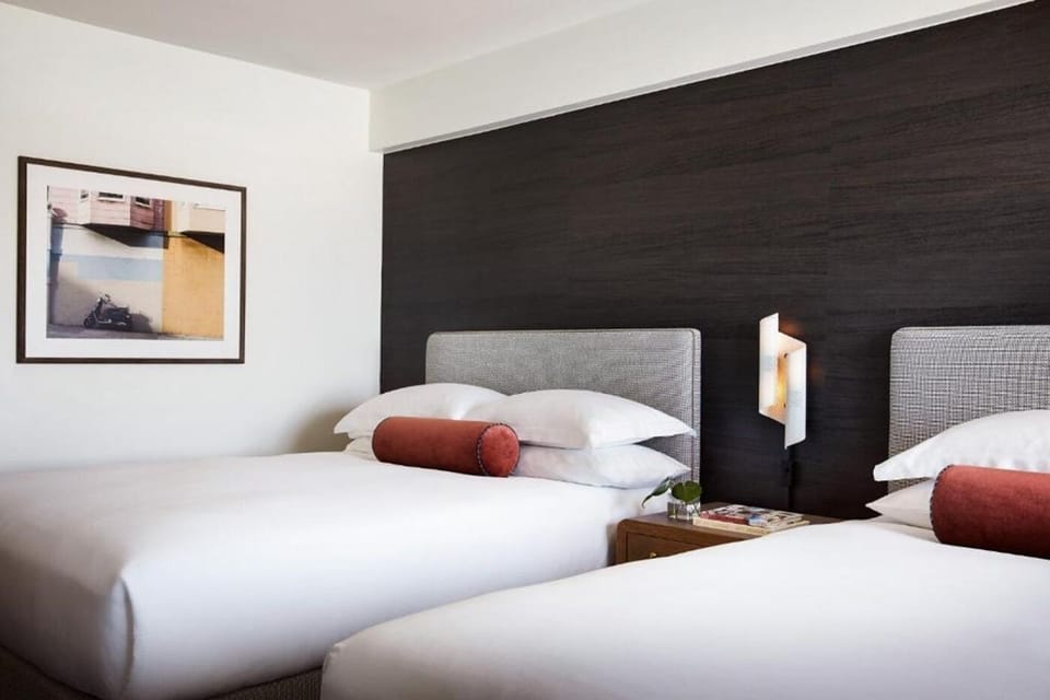 Recharge in a minimalist room accented by warm, modern lighting.