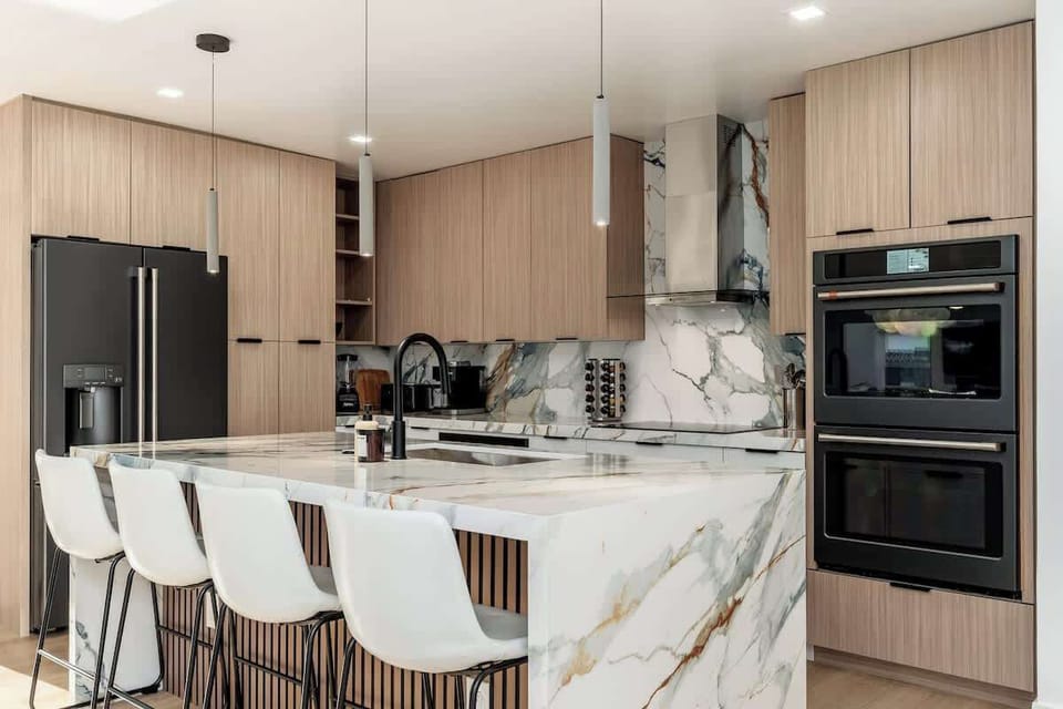 Your fully-equipped gourmet kitchen features stunning marble countertops, modern appliances, and a spacious island—perfect for cooking, gathering, and creating memorable meals together.