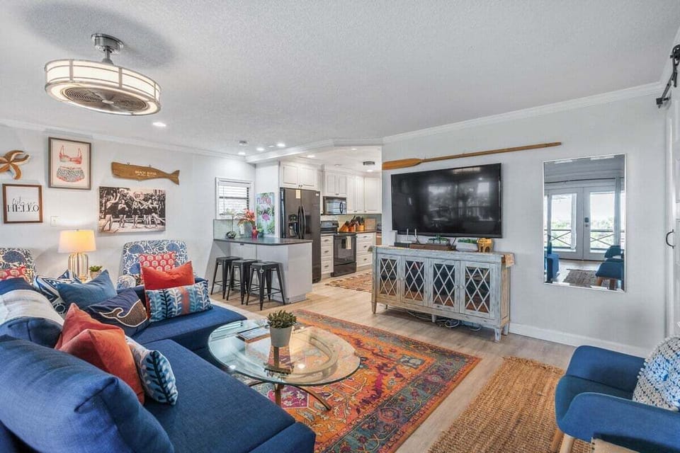 Step into the heart of this stunning vacation retreat, where an open floor concept seamlessly connects the living room, dining area, and kitchen, creating a bright and airy space perfect for gathering.