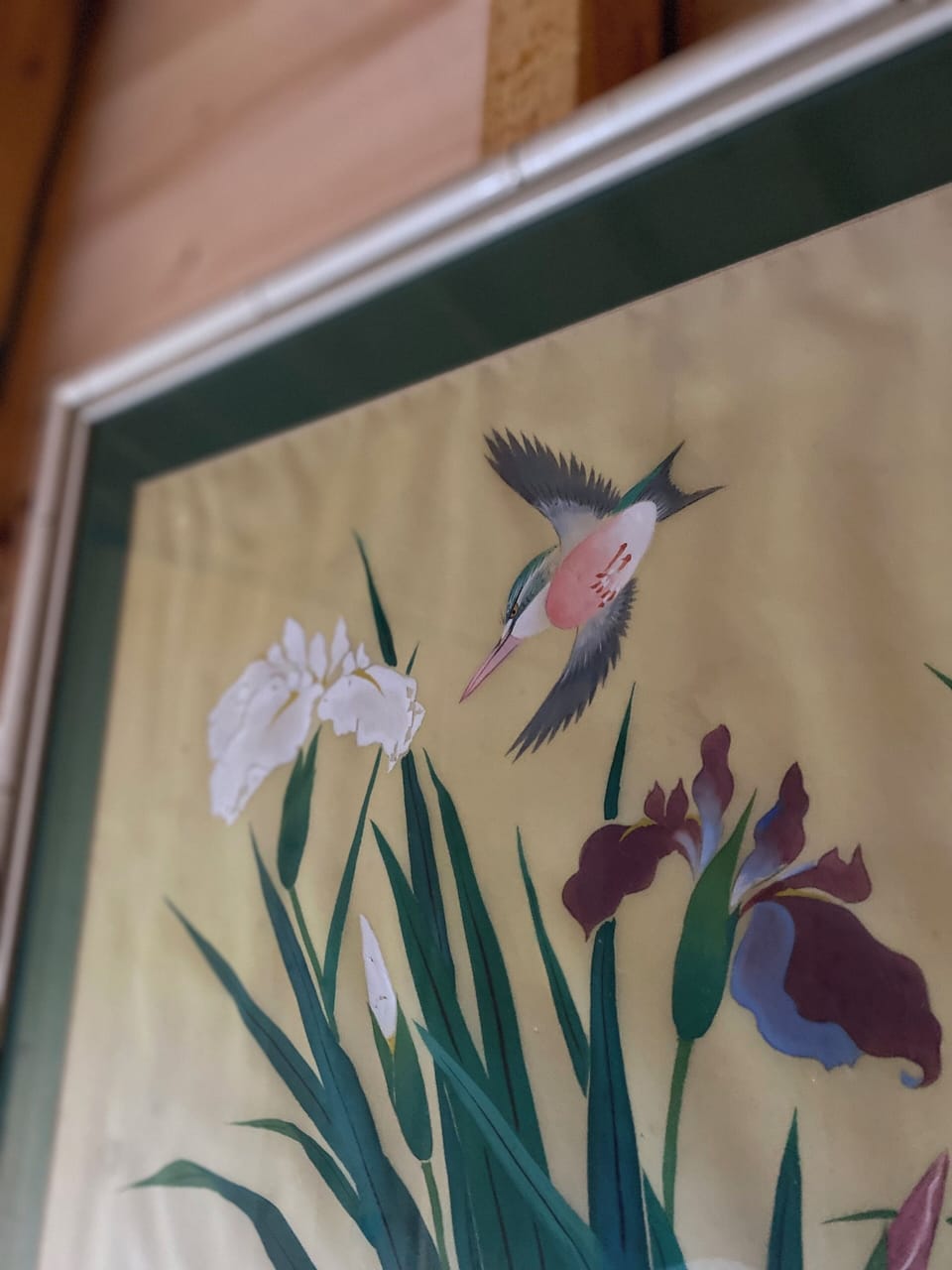 Artwork with birds and flowers next to the bedroom window with the meadow view.