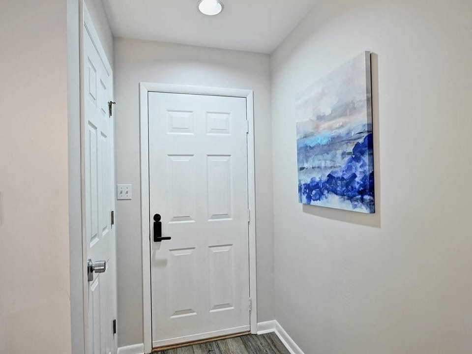 A well-lit entryway with a modern coastal touch, setting the tone for a relaxing beach retreat.
