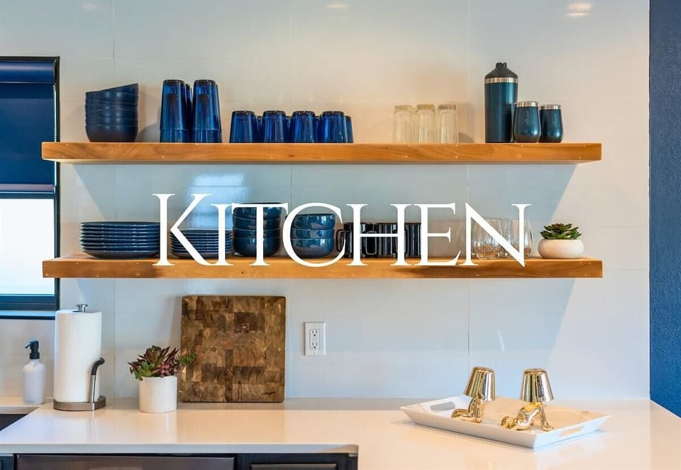 This modern kitchen offers open shelving and sleek finishes, creating the perfect space for preparing meals and enjoying conversation.