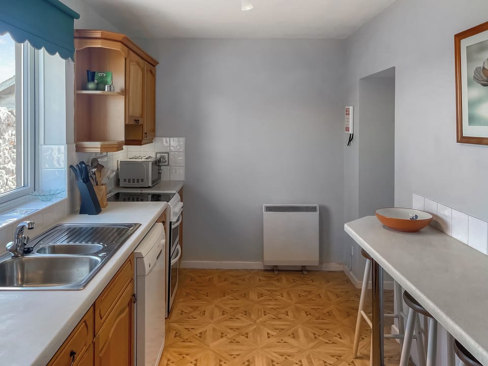 Kitchen taken from the utility room. | Shepherd&rsquo;s Cottage - Elwick Farm Holiday Cottages, Belford