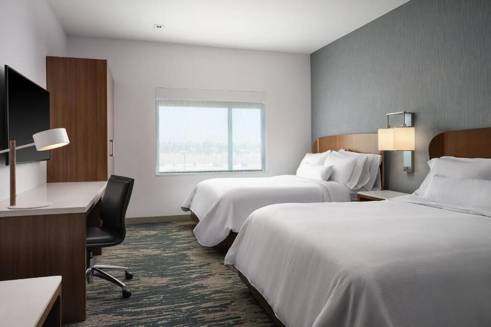 Recharge in quiet comfort with a workspace and soft bedding.
