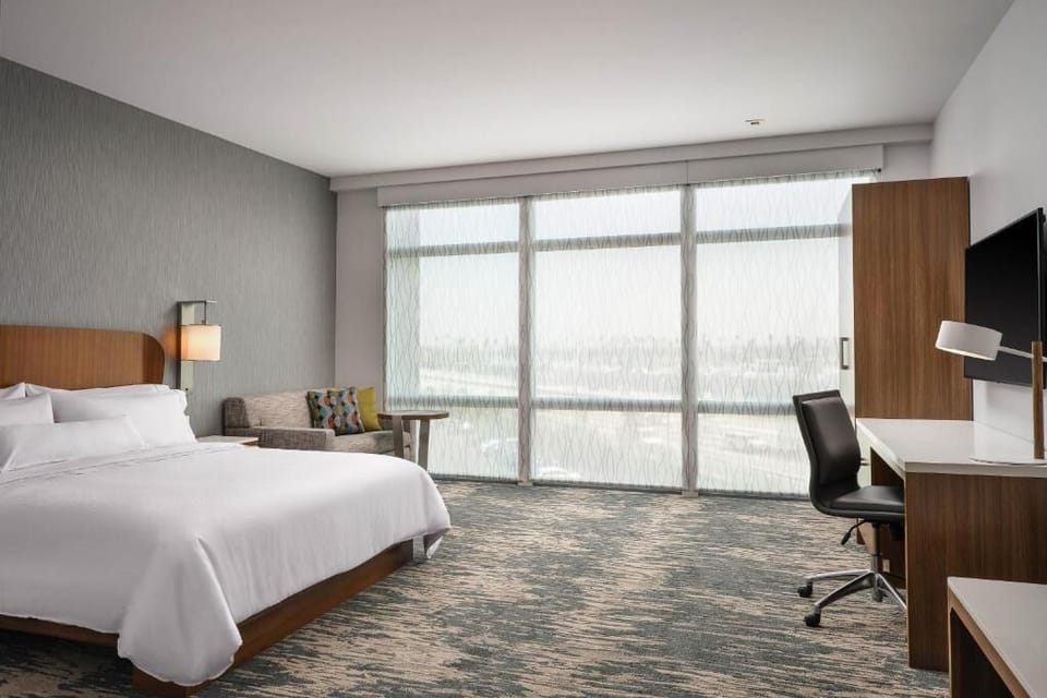 Wake up refreshed in a sunlit king room with workspace.