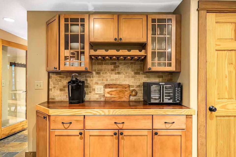 Modern kitchen with a combination toaster oven/air fryer, etc., and a Keurig coffee maker.
