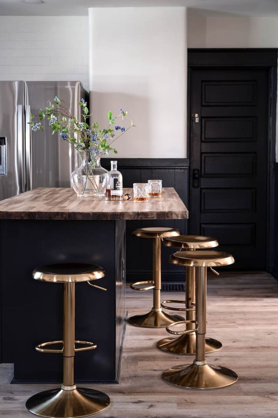 Entertain in style on this gorgeous kitchen island featuring a sleek butcher block countertop, perfect for preparing delicious meals and sipping on some of Kentucky's finest bourbon!