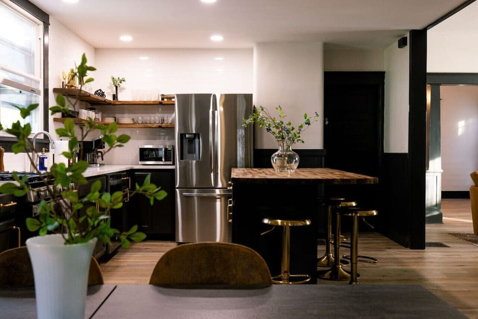 Cook, dine, and gather in our fully equipped kitchen! ✨ With sleek stainless steel appliances, an inviting island, and charming open shelving, this space is designed for memorable meals and great conversations.