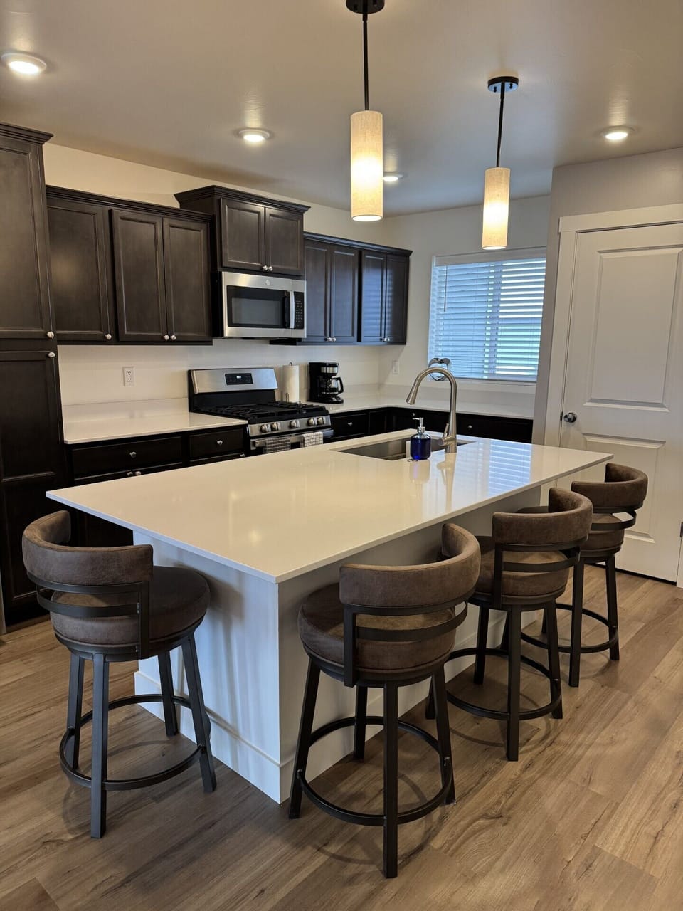 Fully equipped kitchen with spacious island that seats 4 comfortably.