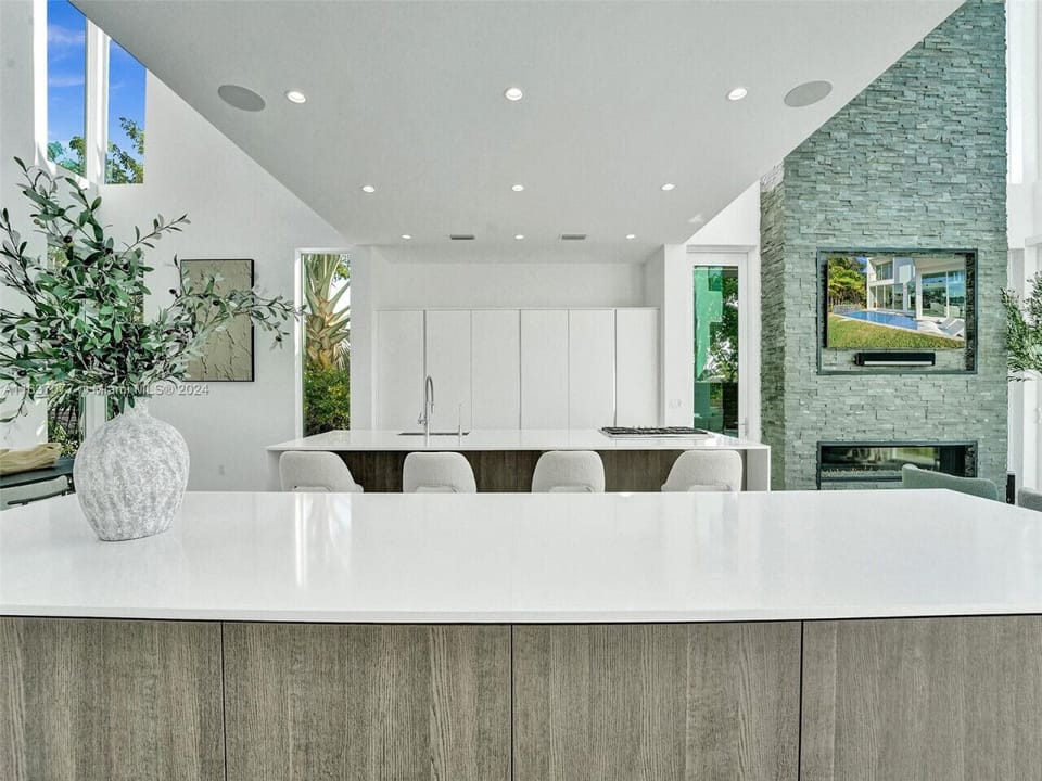 Refined culinary space showcasing dramatic natural stone accents with modern appliances and thoughtful architectural lighting