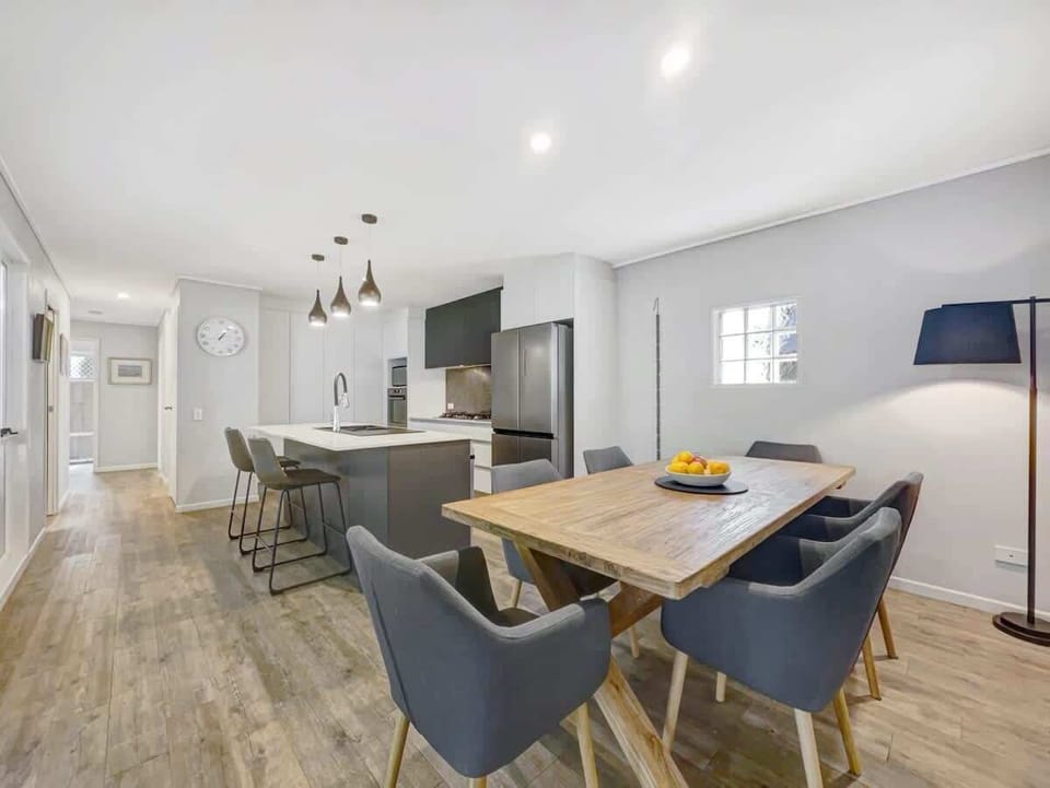 The timber dining table comfortably seats six guests for meals at home.