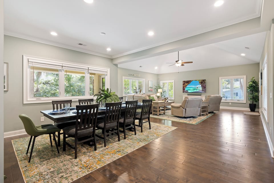 Natural light floods the space through large windows offering lovely Lowcountry views, while vaulted ceilings add an airy, open feel.
