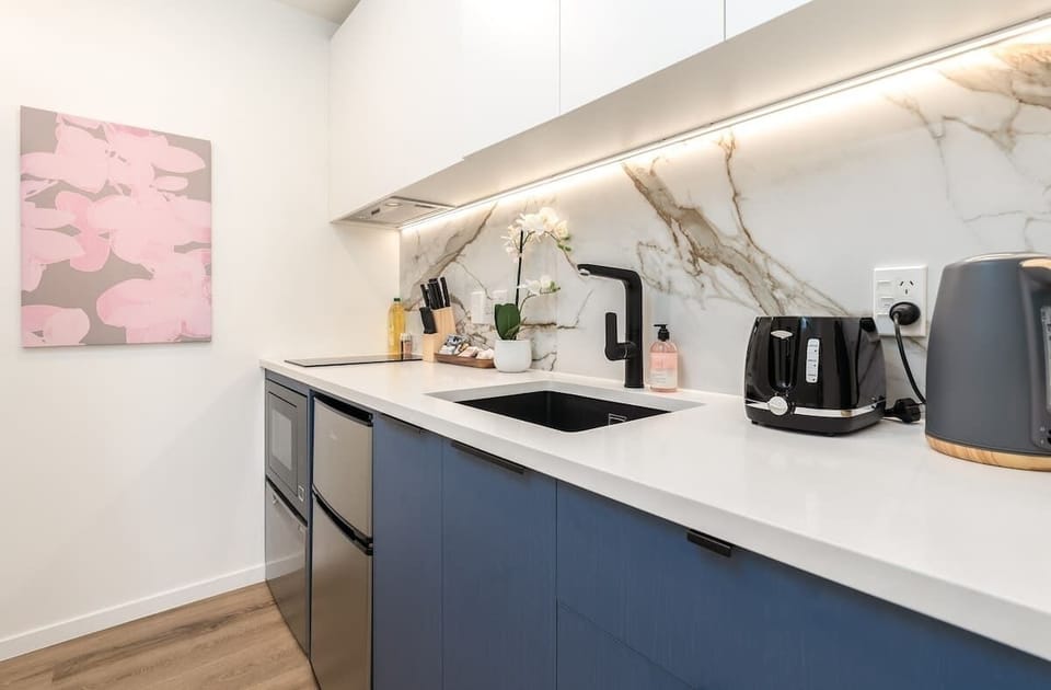 Enjoy culinary freedom in our compact kitchen, equipped with a fridge/freezer, microwave, stovetop, and essential cooking ware. Perfect for easy meals and snacks on the go.