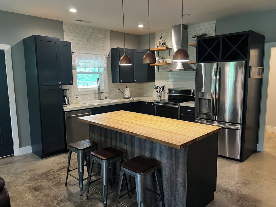 Kitchen includes 3 barstools for countertop dining.