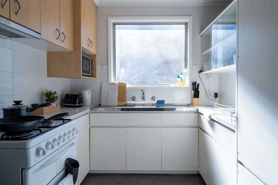 Functional Kitchen with Large Refrigerator and Ample Bench Space