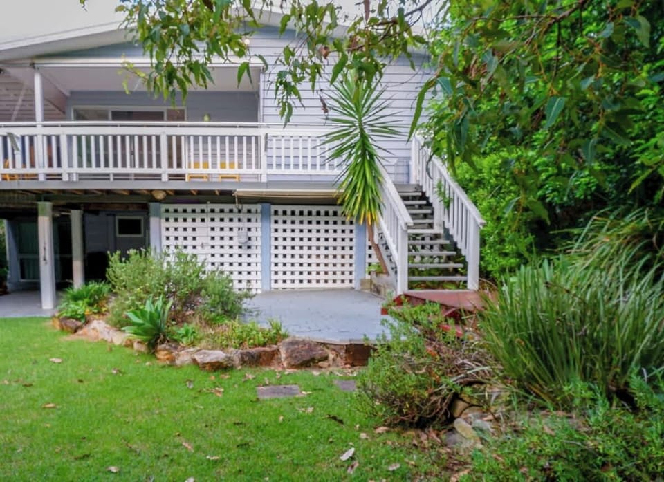 Tucked away and shaded, this backyard nook offers a BBQ, lawn space, and a spot to relax or play.