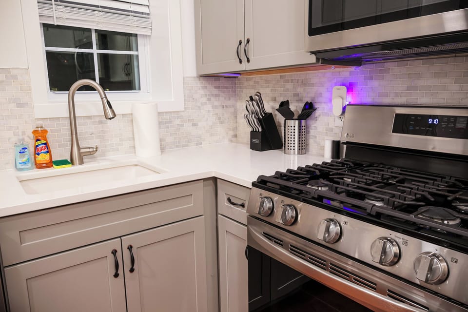 Large windows flood the kitchen with natural light, creating a bright and cheerful ambiance. Take a moment to enjoy a cup of coffee at the breakfast bar or simply relish the joy of cooking in this thoughtfully designed and fully equipped kitchen. It's not just a place to cook; it's a culinary haven for your stay."





