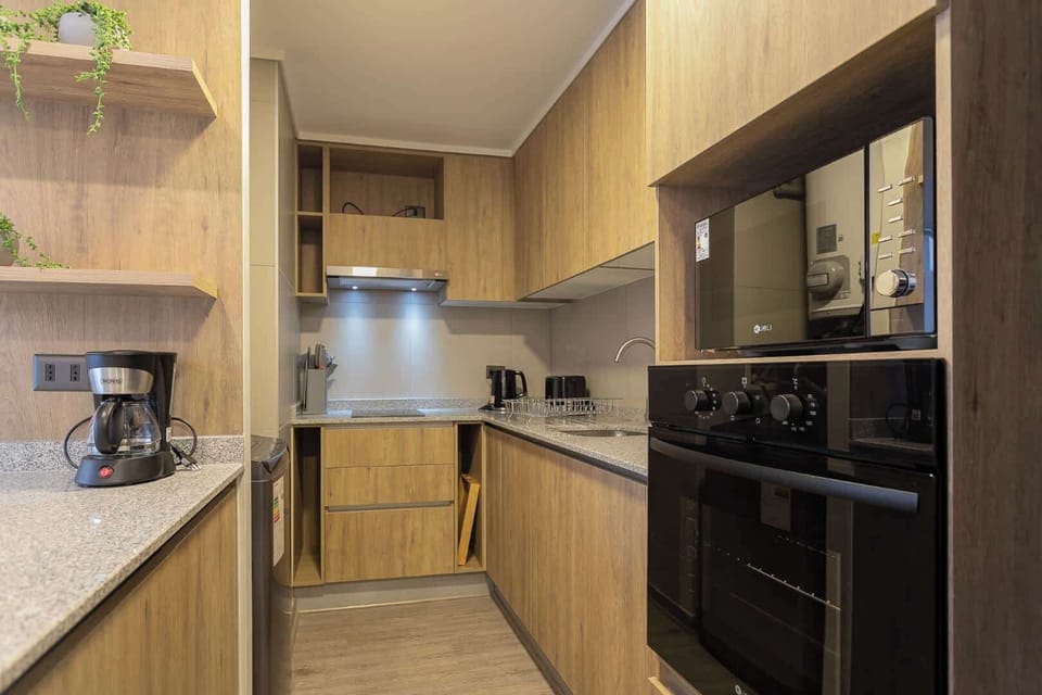 Modern kitchen with sleek granite countertops and essential appliances, perfect for preparing meals during your stay.