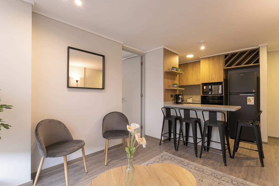Stylish living area with a cozy kitchenette, perfect for relaxing after a day of adventure. Enjoy modern comforts in a welcoming space!