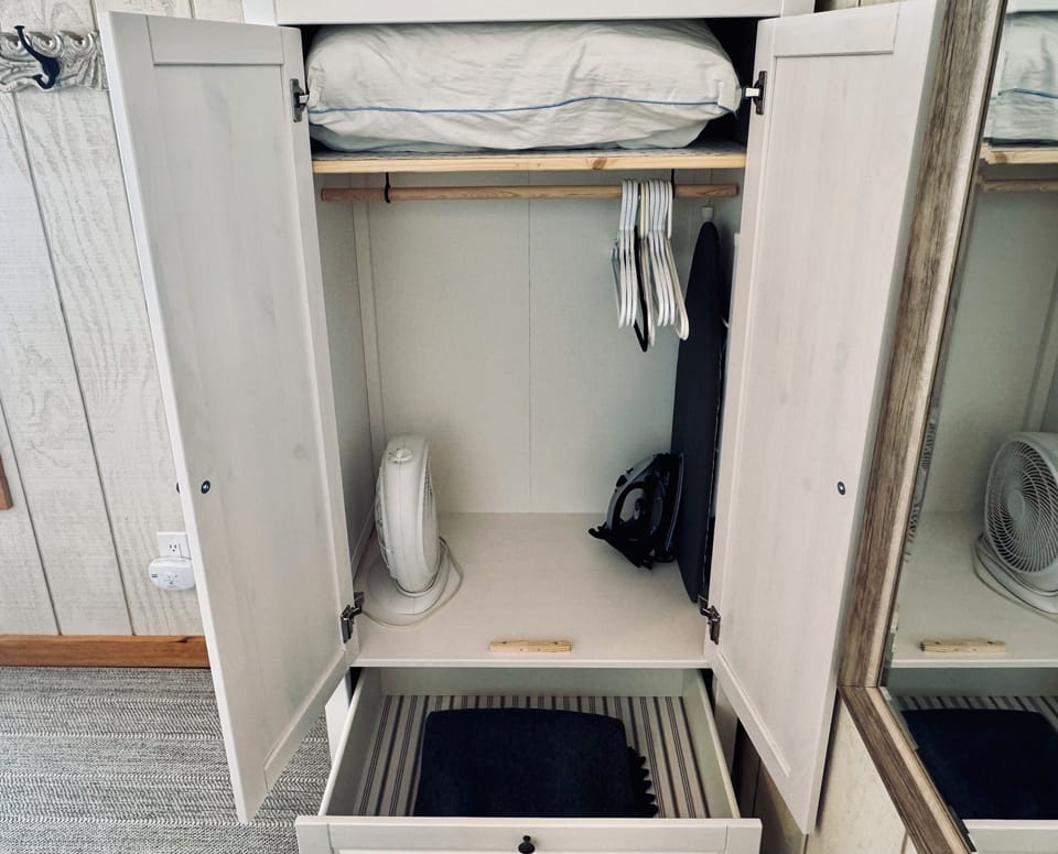 Wardrobe for storage, iron & board, extra pillow & blanket.