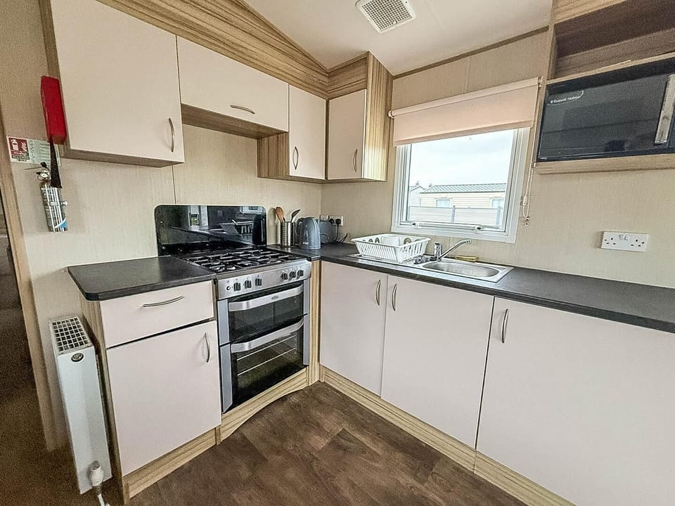 Bright, compact kitchen with modern appliances and natural light