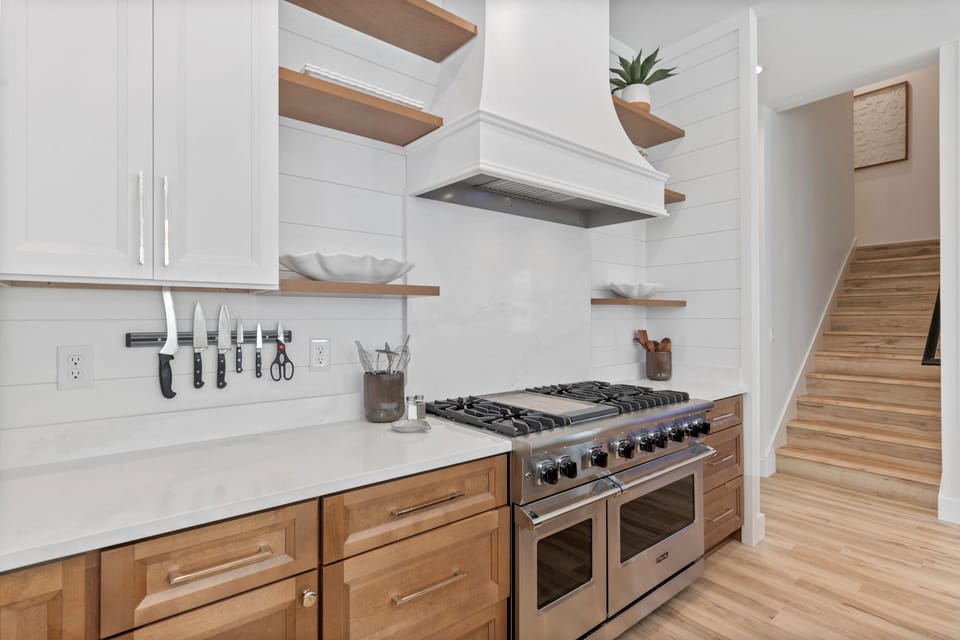 Chef’s kitchen with high-end appliances, including a 48” Viking gas range, dual dishwashers, and built-in microwave