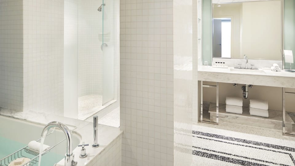 Refresh in a spotless bath with glass shower and vanity.