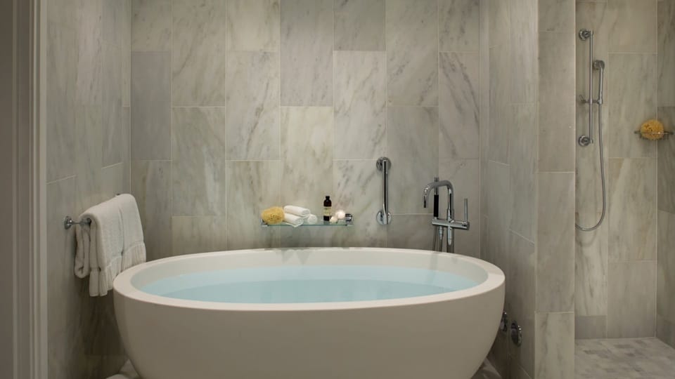 Recharge with a deep tub and rainfall-style shower nearby.