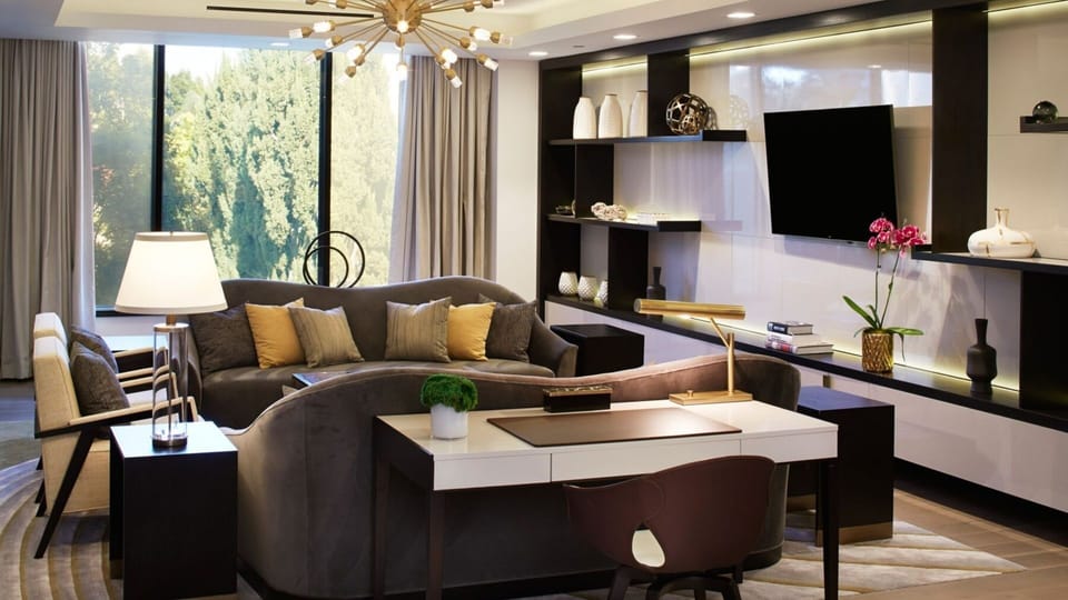 Unwind on plush seating beneath warm, designer lighting.