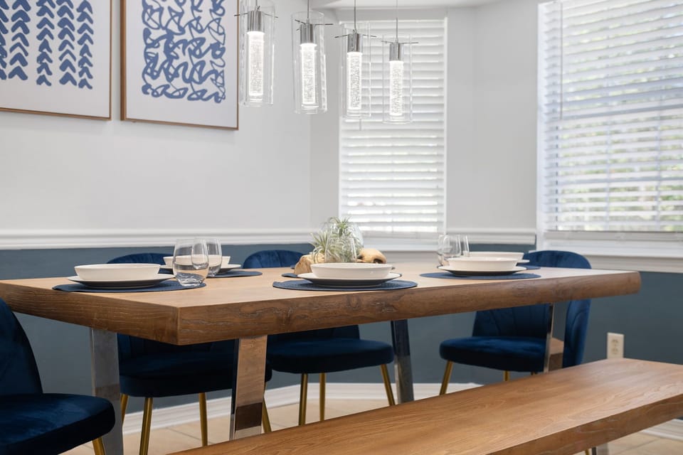 Stylish table setting under modern pendant lights.