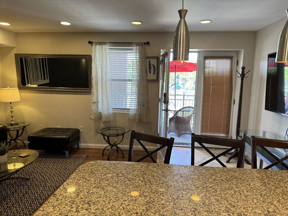 Living room /kitchen area: fridge, microwave, TV, blender, regular coffee maker, plates, silverware, cups, bowls, pen, etc.