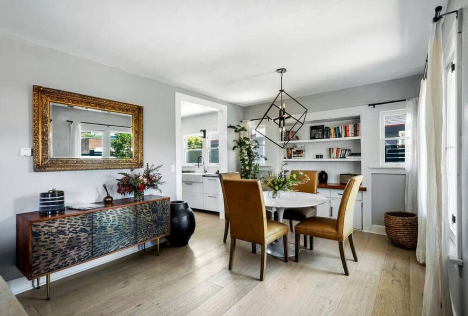 Dining Area with Wooden Chairs and a Stylish Overhead Light,