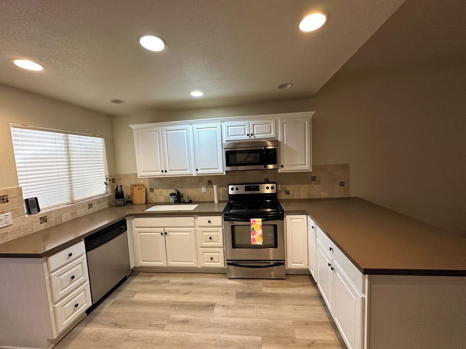 Open concept kitchen with stainless steel appliances.